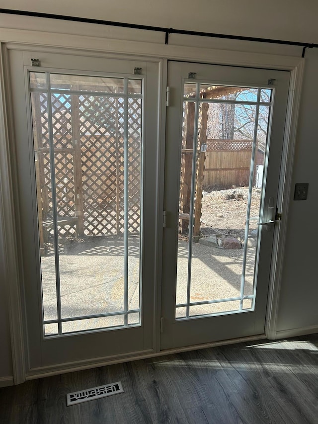 doorway to outside featuring dark wood-type flooring