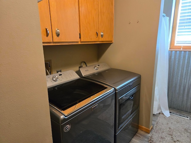 laundry area with cabinets and washer and dryer