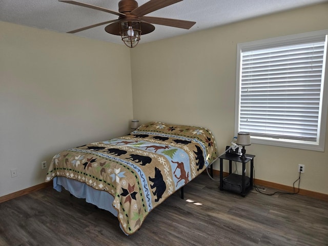 bedroom with ceiling fan and dark wood-type flooring