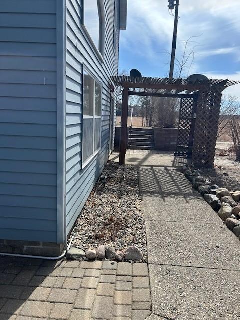 view of gate featuring a pergola