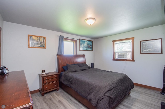 bedroom featuring cooling unit and light hardwood / wood-style flooring