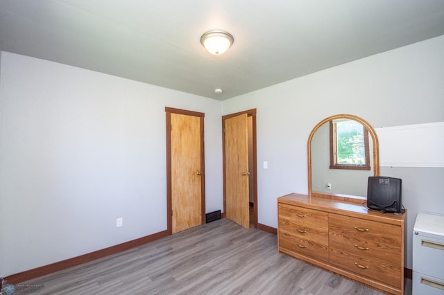 bedroom with light wood-type flooring