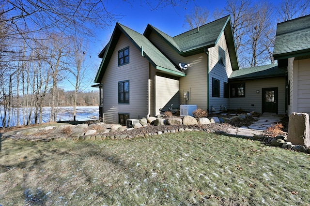 view of property exterior featuring ac unit, cooling unit, and a lawn