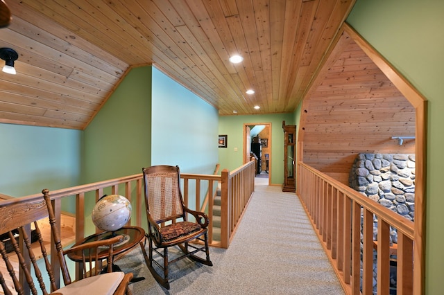 hallway featuring light colored carpet, vaulted ceiling, and wooden ceiling