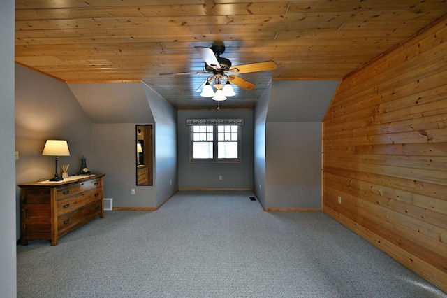 additional living space with ceiling fan, light colored carpet, vaulted ceiling, and wooden ceiling