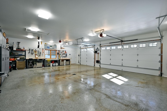 garage with a garage door opener and a workshop area