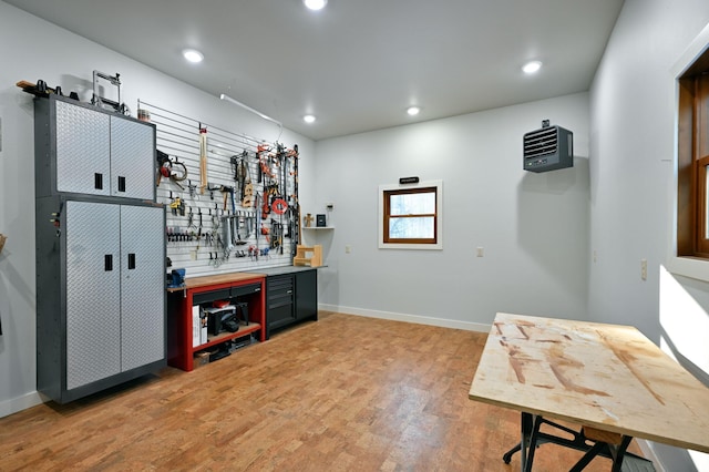 bar featuring wood-type flooring and a workshop area