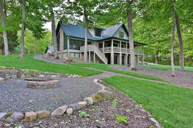 2772 25th Ave Unit B, Cedar Lake Twp, WI 54868 - rear view of property with a fire pit, a lawn, stairway, a deck, and roof with shingles