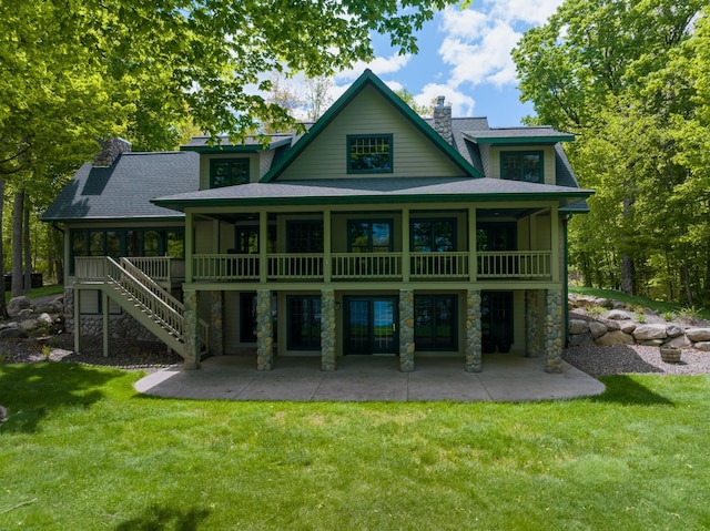 2772 25th Ave Unit B, Cedar Lake Twp, WI 54868 - rear view of house with a chimney, a patio, a yard, and stone siding