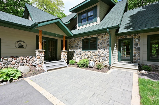 2772 25th Ave Unit B, Cedar Lake Twp, WI 54868 - entrance to property featuring stone siding, a porch, and roof with shingles