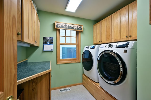 2772 25th Ave Unit B, Cedar Lake Twp, WI 54868 - laundry room featuring washer and clothes dryer, cabinet space, and light tile patterned flooring