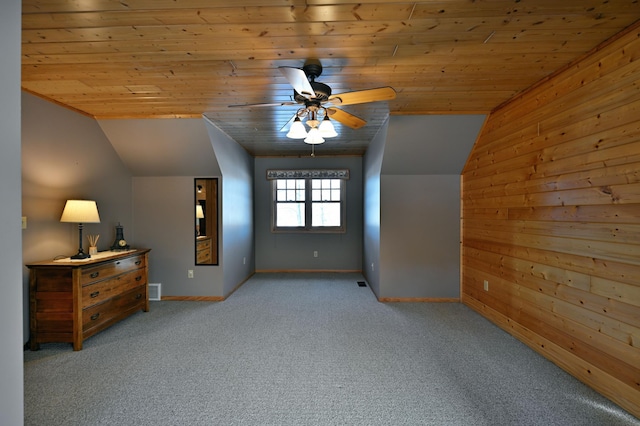 2772 25th Ave Unit B, Cedar Lake Twp, WI 54868 - unfurnished bedroom featuring wood ceiling, vaulted ceiling, carpet floors, wooden walls, and a ceiling fan