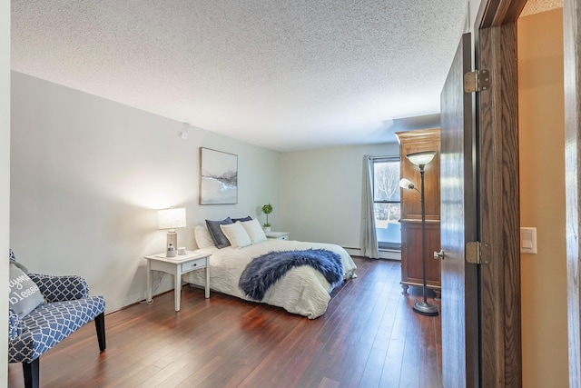 bedroom with dark wood-type flooring and a textured ceiling