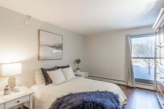 bedroom with dark wood-style flooring and baseboard heating