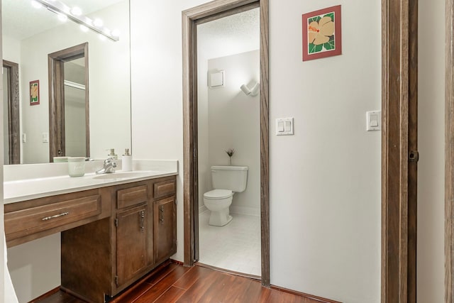 full bathroom with vanity, wood finished floors, and toilet