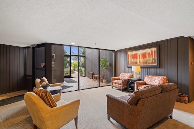 living area featuring a textured ceiling, light carpet, and floor to ceiling windows