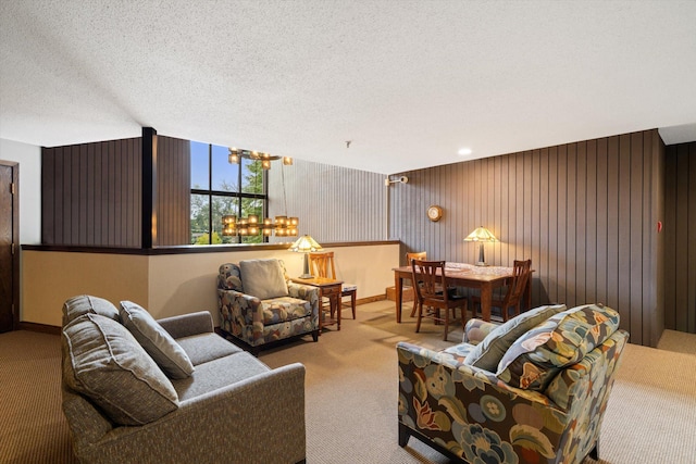 living room with light colored carpet, a textured ceiling, and baseboards