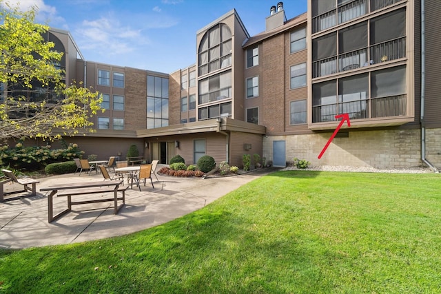 view of community featuring a patio and a yard