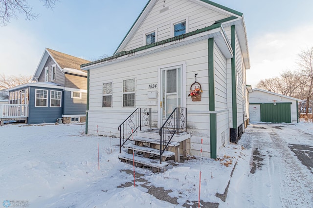 view of front facade with a garage and an outbuilding