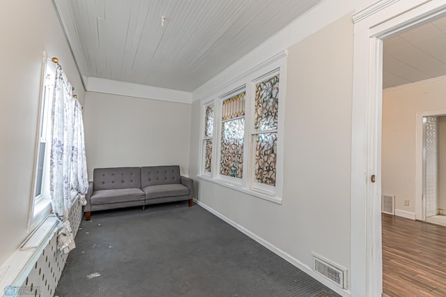 unfurnished room with dark carpet, ornamental molding, and wooden ceiling