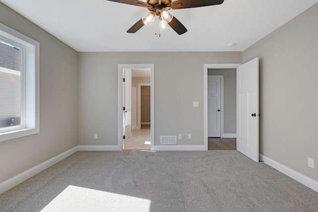 unfurnished bedroom featuring ceiling fan and light colored carpet