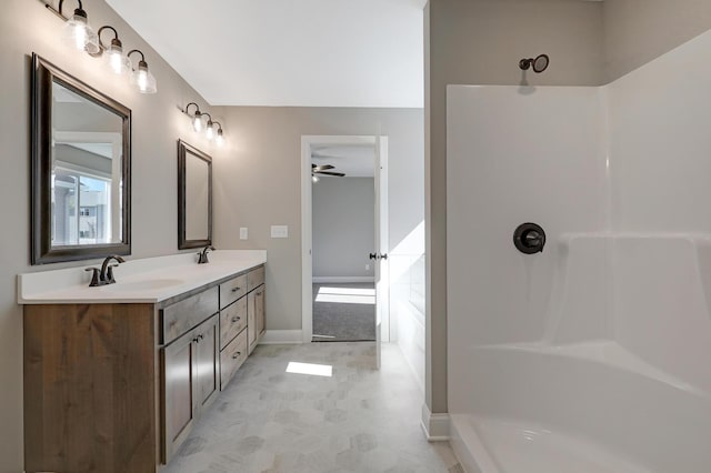 bathroom with vanity and a shower