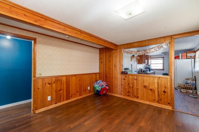 interior space with dark wood-type flooring and a textured ceiling