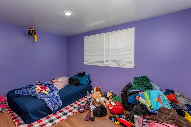 bedroom with wood-type flooring