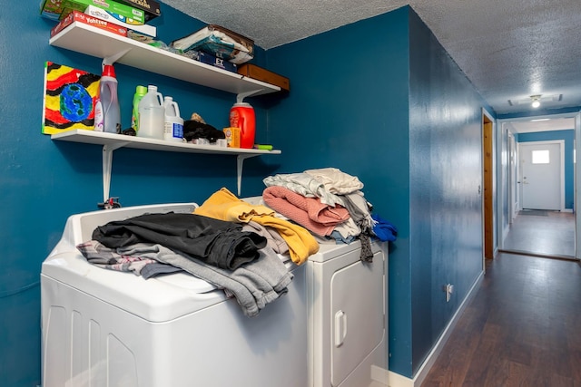 washroom with separate washer and dryer, dark wood-type flooring, and a textured ceiling