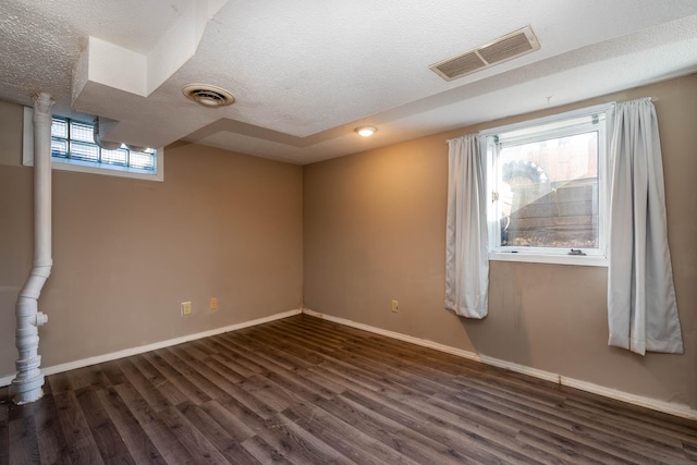 interior space with dark hardwood / wood-style flooring and a textured ceiling