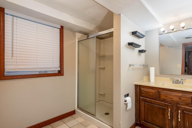 bathroom with tile patterned floors, vanity, and an enclosed shower