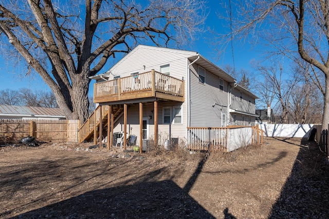 back of property with a wooden deck