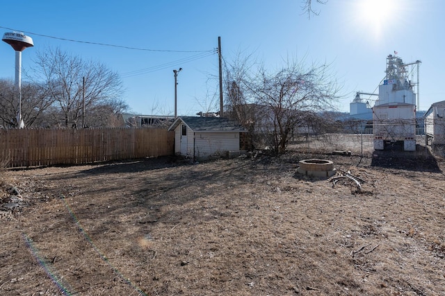 view of yard with a storage unit and a fire pit