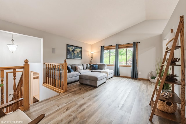 living room with lofted ceiling and light hardwood / wood-style flooring