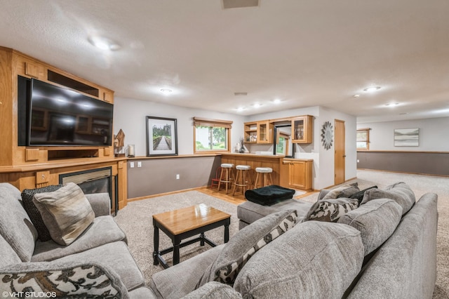 carpeted living room featuring bar