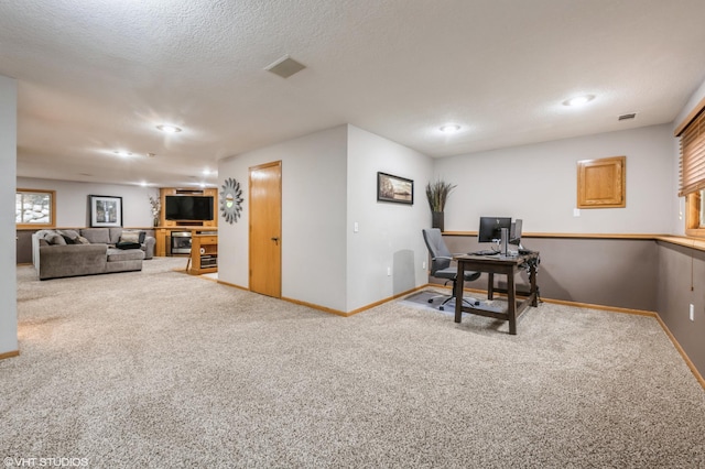 office space featuring carpet flooring and a textured ceiling