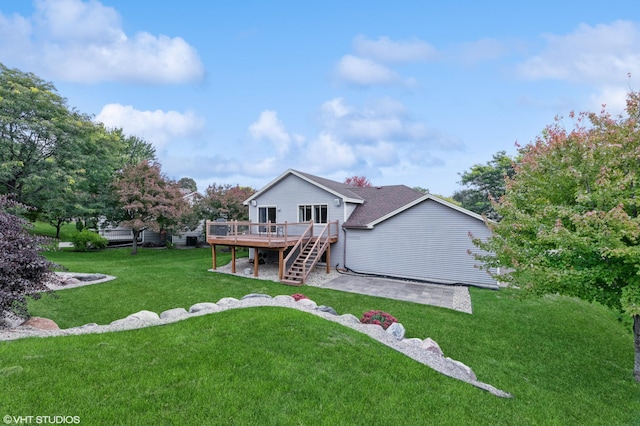 rear view of house featuring a yard, a deck, and a patio area