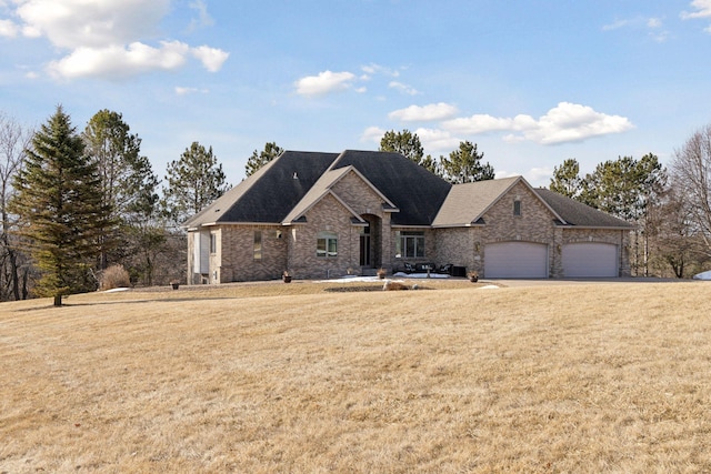 view of front of home featuring an attached garage and a front yard