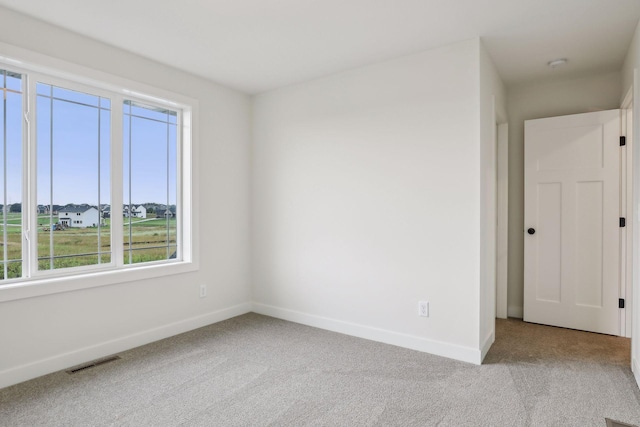 unfurnished room with light colored carpet