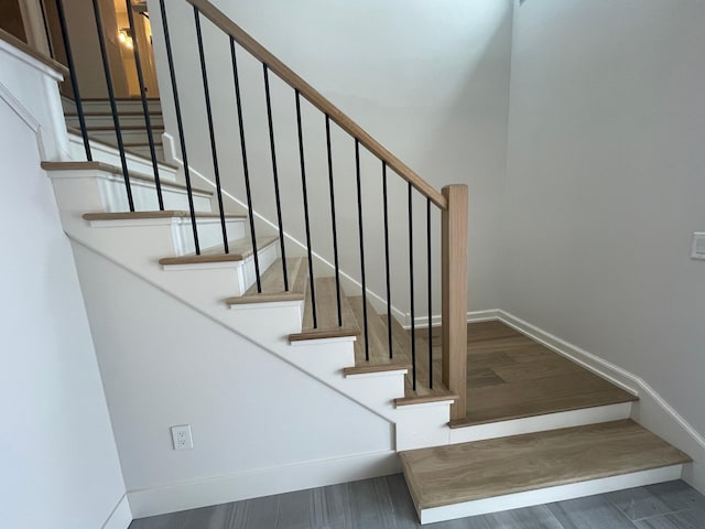 staircase featuring hardwood / wood-style flooring