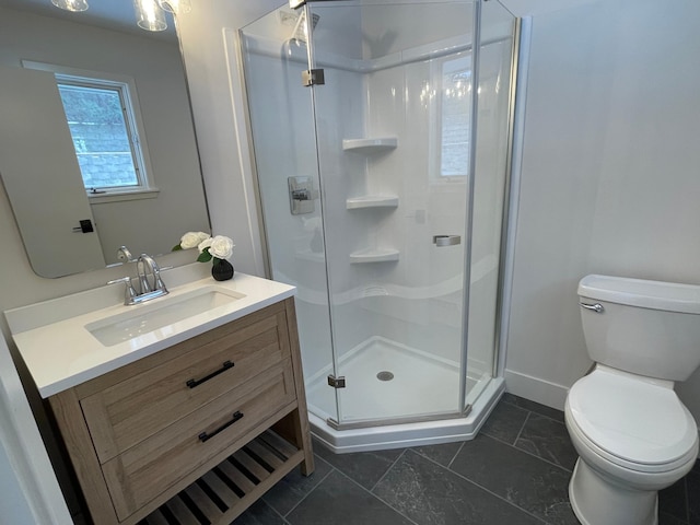 bathroom with vanity, toilet, and an enclosed shower