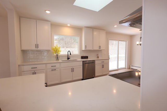 kitchen with a baseboard heating unit, dishwasher, sink, and white cabinets