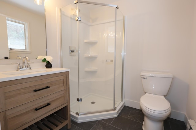 bathroom with vanity, toilet, and a shower with shower door