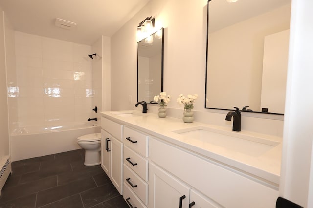 full bathroom with tiled shower / bath combo, vanity, a baseboard heating unit, and toilet