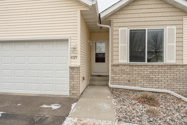 doorway to property featuring a garage