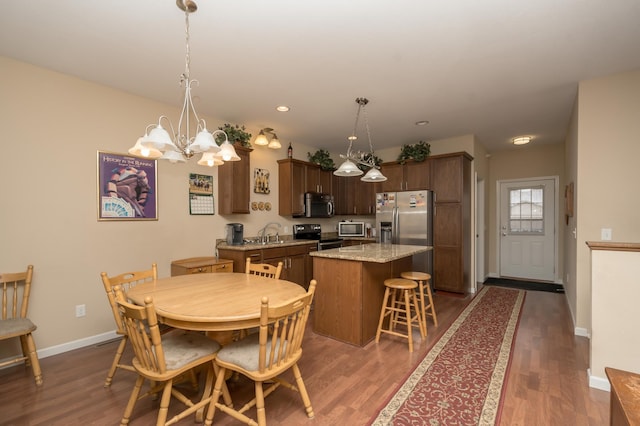 dining room featuring dark hardwood / wood-style flooring, sink, and a chandelier