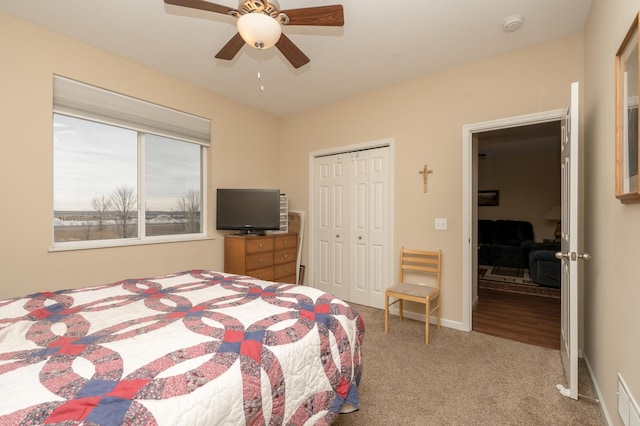 carpeted bedroom featuring a closet and ceiling fan