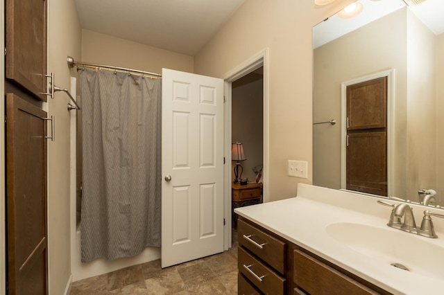 bathroom with shower / bath combo and vanity