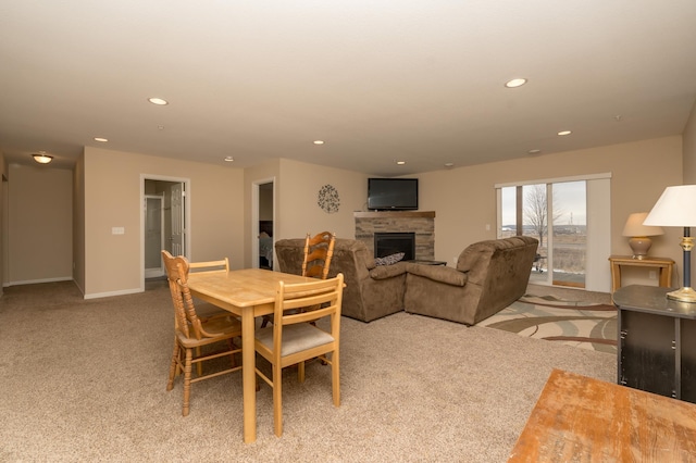 carpeted dining room featuring a fireplace