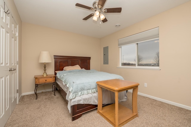 bedroom featuring ceiling fan, electric panel, and light carpet